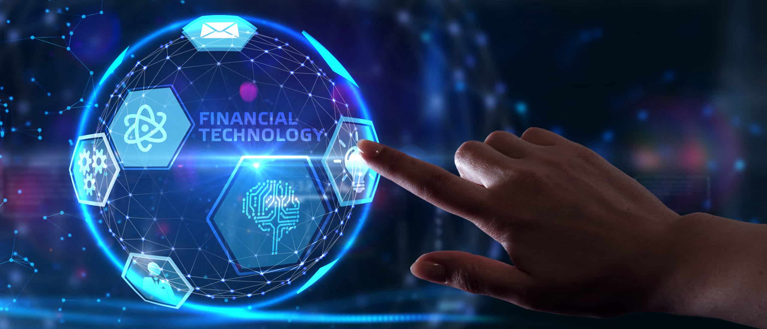 Fintech -financial technology concept.Young businessman select the icon Fintech on the virtual display.